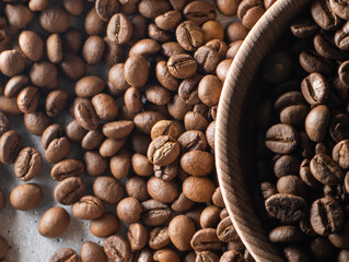 Brown roasted coffee beans falling on pile. Represent breakfast, energy, freshness or great aroma,Flying on dark background with copy space, close-up