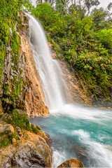Obraz premium Blue water flowing through Gemelas waterfalls in Bajos del Toro, Costa Rica