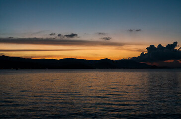 Fototapeta na wymiar Sea view with sunset over the mountains.