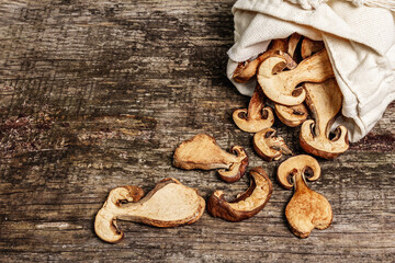 Forest dried edible mushrooms in a linen sack