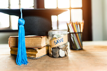 hat graduation and money coins saving for concept investment education and scholarship