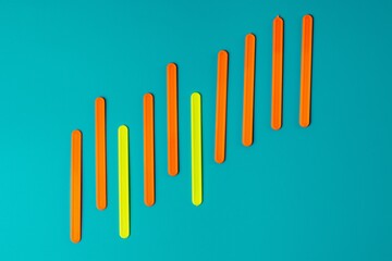 Colored sticks in the form of a graph of profit against the background of the color of sea water.