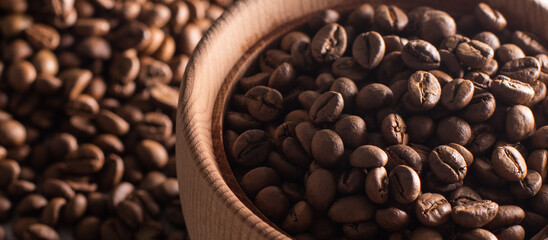 Coffee beans in a wooden cup