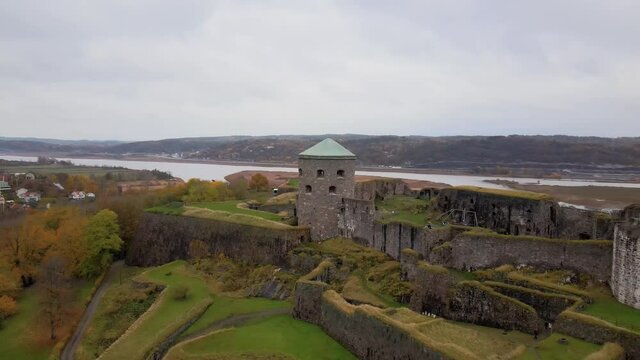 Aerial view of the old fortress Bohus f&auml;stning one cloudy autumn day in Kung&auml;lv, Sweden. Green and yellow colored trees. 4K stabilized drone footage.