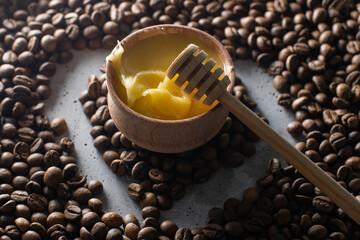 honey and coffee beans on wood background, abstract