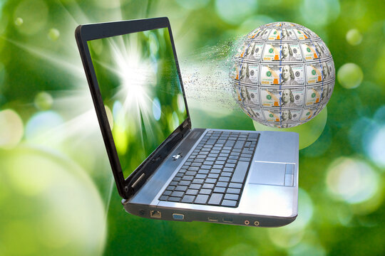 An image of a laptop and a ball of money flying out of the screen. Small particles are separated from the ball.3d-image