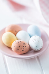 Chocolate easter eggs. Sweet candy eggs on pink plate.