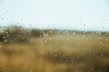 Raindrops on the window. Autumn or spring. Background and texture.