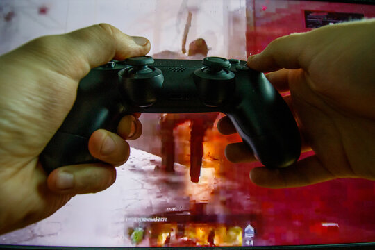 Man play video game on PlayStation 4 console. Point of view shot. Video games addiction. FIFA gameplay
