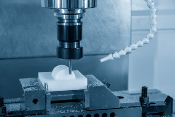 The  CNC  milling machine cutting  the POM material part by solid ball  end-mill tool. The...