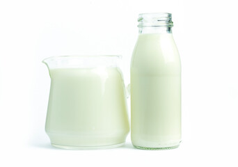 Pure milk beverage in clear jars and bottles is a natural, healthy, white background with clipping path.