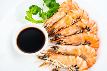A plate of boiled black tiger prawns and seasoning sauce