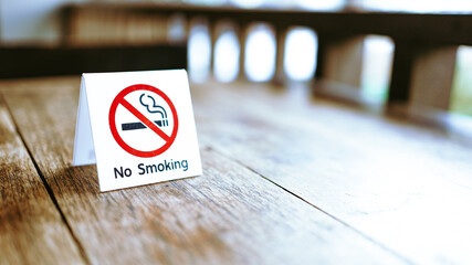 No Smoking label in the public. No smoking sign on wood table at hotel