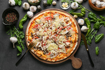 Board with tasty pizza on dark background