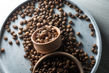 Brown roasted coffee beans falling on pile. Represent breakfast, energy, freshness or great aroma,Flying on dark background with copy space, close-up