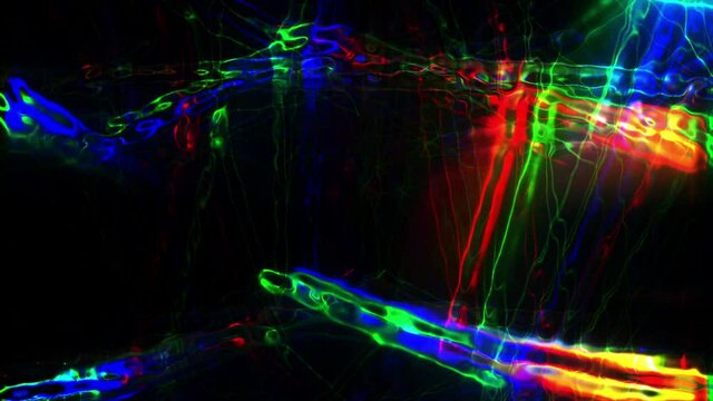 Colored flashing lights from strips of liquid glass flicker in motion. Abstract disco entertaiment of streaks stream illumination on black Neon laser beams are pulsed and fluid with a twinkling plexus