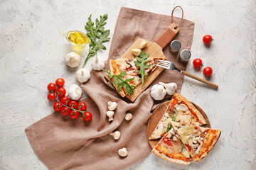 Plate and board with slices of tasty pizza on light background