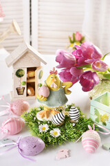 Easter table decoration with hen figurine and colorful eggs