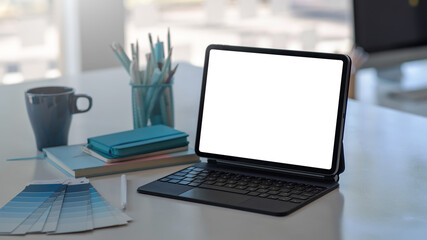 Mockup of a blank white screen tablet on the table in the office.
