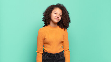  looking happy and friendly, smiling and winking an eye at you with a positive attitude