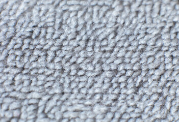Grey cotton towel or carpet.fluffy texture background. Close up photo.