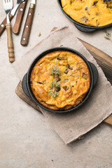 Frittata with mushrooms in a pan on wooden background. Fritata is an Italian breakfast dish.