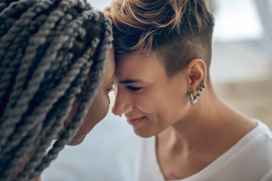 Same-sex couple standing close and looking in love