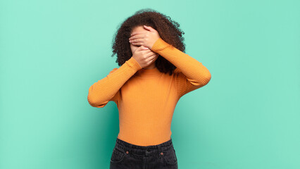  covering face with both hands saying no to the camera! refusing pictures or forbidding photos