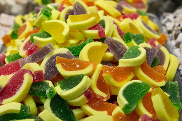 Fruit jelly in form of pieces of citrus fruits in an oriental sweets store.