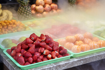 Chilled fruits on counter of  fruit shop.