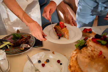 newlyweds cut off a traditional wedding cake. End of the holiday.
