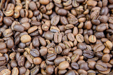 Roasted coffee beans on counter in coffee shop.