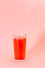 red berries juice on pink background, monochrome color
