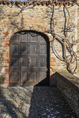 Entrance door of the Castle of Serralunga d'Alba, one of the best preserved examples of noble castle of the 14th century in Piedmont, Cuneo province, Italy