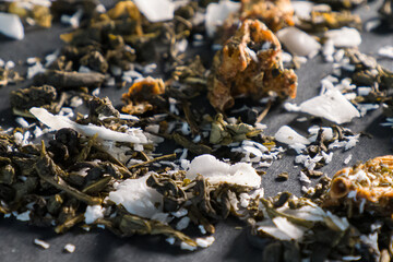 the dry tea with coconut on a black background
