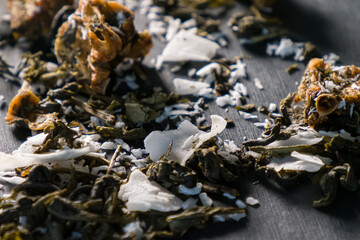 the dry tea with coconut on a black background