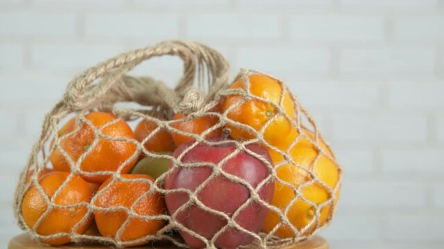 String shopper with products. Fruits in an eco string bag.