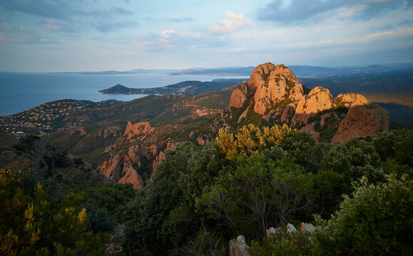 A wonderful view from the Pic du Cap Roux towards Cap du Dramont and Saint Raphael, shortly after sunrise. The mountains of the Esterel massif shine bright red. 