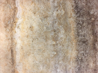 Beautiful glossy marbled surface in beige, brown and cream with patterns and speckles. Marble is a metamorphic rock composed of recrystallized carbonate minerals, most commonly calcite or dolomite.