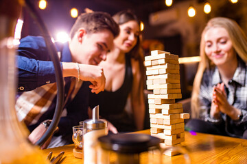 Young people have fun playing board games at a table