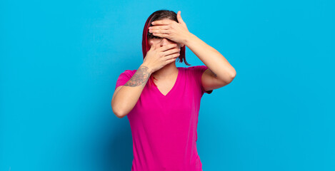  covering face with both hands saying no to the camera! refusing pictures or forbidding photos