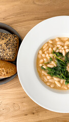 
Plate of white beans with vegetables. Vegetal protein. Vegetarian diet