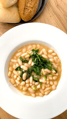 
Plate of white beans with vegetables. Vegetal protein. Vegetarian diet