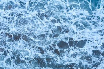 background, texture - stormy sea water with waves and foam