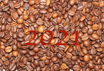 Coffee beans close-up in the background. The texture of the coffee bean