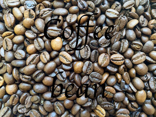 Coffee beans close-up in the background. The texture of the coffee bean