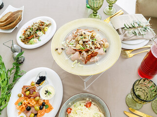 Beautiful festive table, with Greek salad with feta cheese.