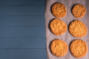 delicious homemade cookies on baking paper on blue wooden background