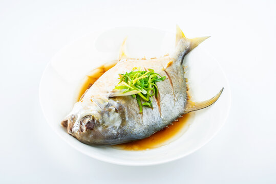 A dish of steamed jinchang fish on white background