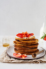 Stack of french toast with cottage cheese, honey and strawberries for breakfast. Selective focus